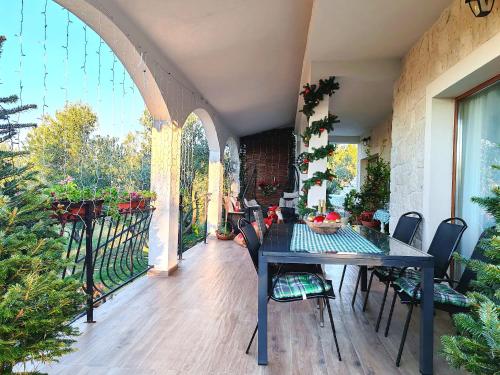 eine Terrasse mit Tisch und Stühlen auf einem Balkon in der Unterkunft Winter holidays in Holiday home Olive garden Platinum in Posedarje