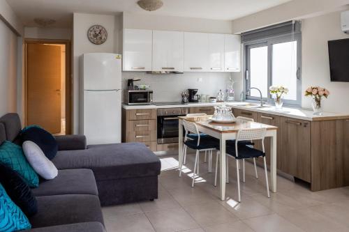 a kitchen and living room with a couch and a table at Placebo Apartment in Kritharia