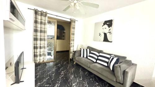 a living room with a couch and a ceiling fan at Castle Harbour 2 Bed Duplex in El Guincho
