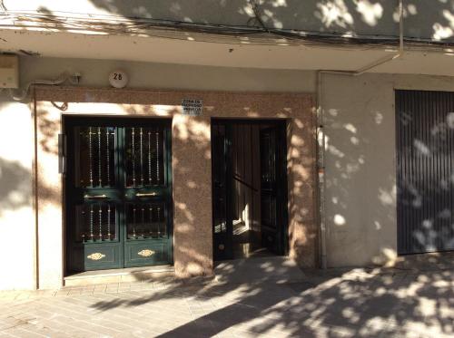 a pair of doors on a building with shadows on it at Apartamento Vergeles-Congresos in Granada