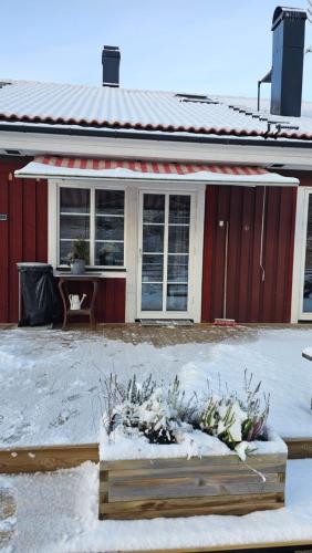 a house with snow on the ground in front of it at Studio Borgen in Sigtuna