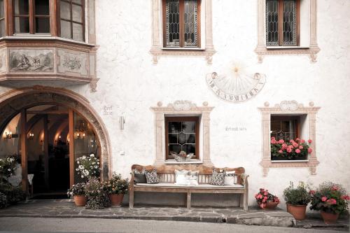 a bench sitting in front of a building at Hotel Hoferwirt - Neustift, Stubai in Neustift im Stubaital