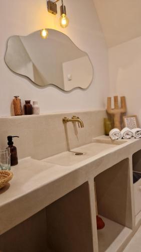 a bathroom with a sink and a mirror at Maison du Caboteur de La Baule, Centre & plage à pied, Patio cosy, 8 pers in Le Pouliguen