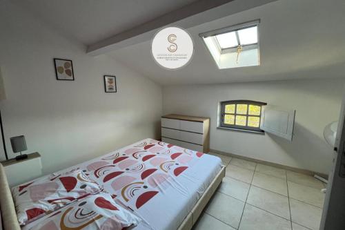 a bedroom with a large bed and a window at Emily in Provence Arles Centre in Arles
