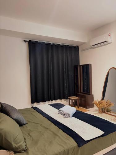 a bedroom with a bed and a window with black curtains at Resilience 9 in Kota Kinabalu
