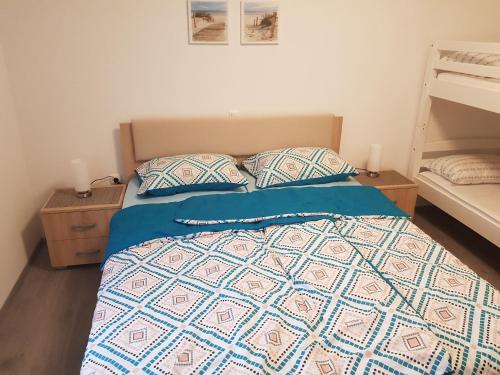 a bedroom with a bed with two pillows at Apartmaji Divji vrt in Lendava