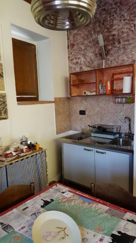 a kitchen with a table and a kitchen with a counter at La Torretta - Cerreto Grue in Sarezzano