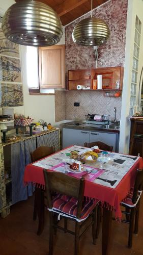 a kitchen with a table with a red table cloth at La Torretta - Cerreto Grue in Sarezzano