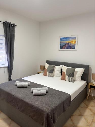 a bedroom with a large bed with two towels on it at Apartmani Gagi in Vir