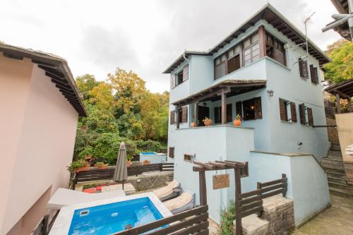 a house with a swimming pool in front of it at Dandy Villas Tsagkarada - Sky Blue Pansy - Jacuzzi in Tsagarada