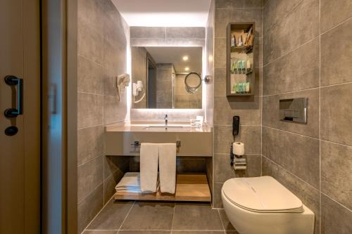 a bathroom with a toilet and a sink at The X Belek in Belek