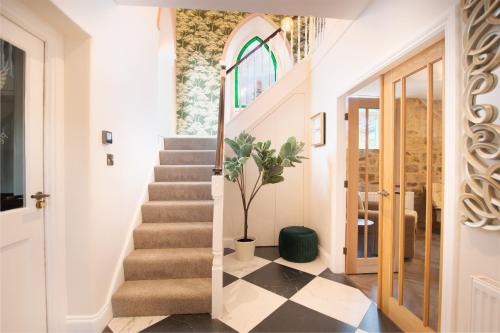 a hallway with a stairway with a window and a stair case at Northern Hideaways The Old Chapel, Otterburn in Otterburn