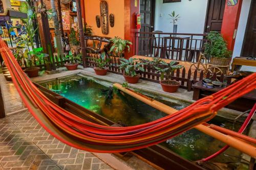 a hammock in a room with a pond at Bulskamp Inn in El Nido
