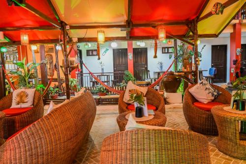a restaurant with wicker chairs and tables in a room at Bulskamp Inn in El Nido