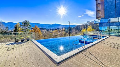 a house with a swimming pool on a deck at Mountain Horizon Valley z basenami, saunami i strefą fitness by Royal Aparts in Szklarska Poręba