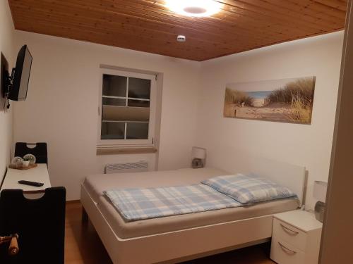 ein kleines Schlafzimmer mit einem Bett und einem Fenster in der Unterkunft Das tolle Ferienhaus an der Mosel für Familien und kleine Gruppen mit bis zu 10 Personen in Ürzig