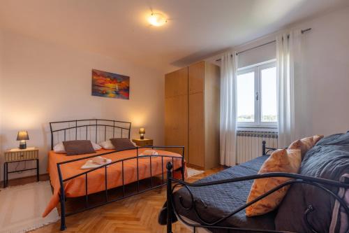 a bedroom with two beds and a window at Casa Jurican in Višnjan