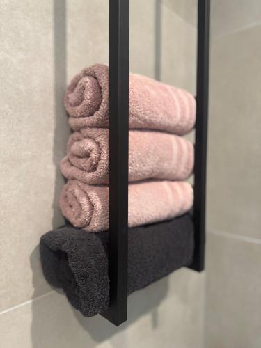a towel rack with pink towels in a bathroom at Tante Ursula B&B in Venlo