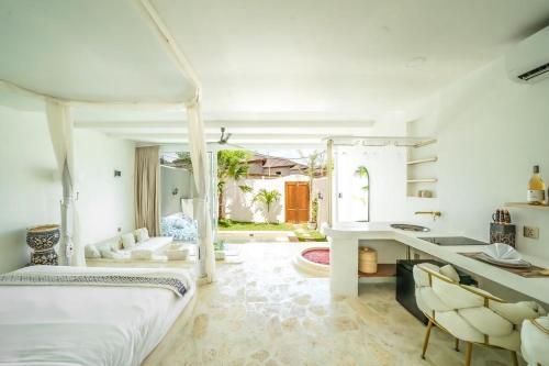 a bedroom with a bed and a desk and chairs at Marghe 1BR Romantic Villa, 5 Mins to Thomas Beach in Badung