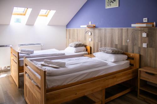 two beds in a room with blue walls at Prague Dream Hostel in Prague
