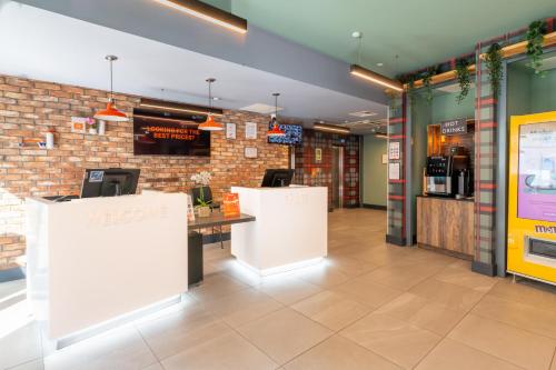 a restaurant with a counter and a brick wall at easyHotel Dublin in Dublin