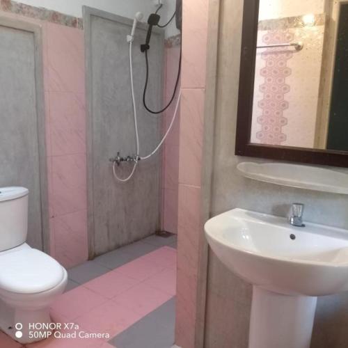 a bathroom with a sink and a toilet and a shower at Derana Villa in Hikkaduwa