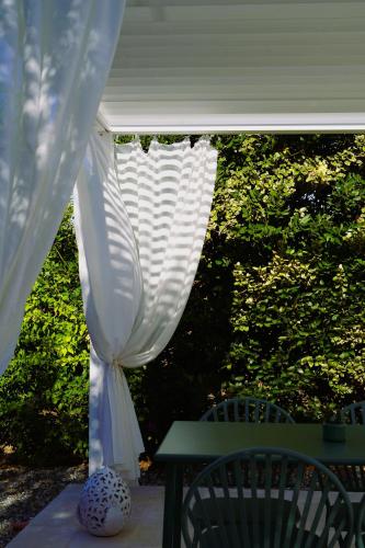a white gazebo with a table and chairs at Trulli Pastore in Alberobello
