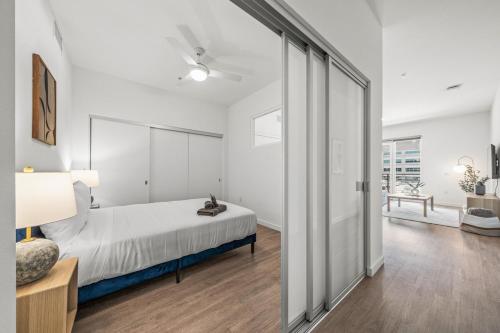 a bedroom with a bed and a sliding glass door at Stylish Condo Mins to Shoreline in Long Beach