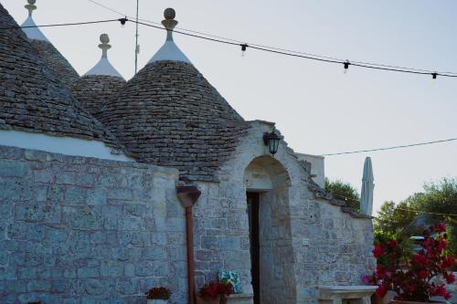 a building with a stone wall with a door at Trulli Pastore in Alberobello