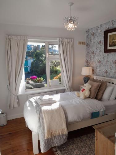 a bedroom with a white bed and a window at Saint Martin's Bed and Breakfast in Bandon