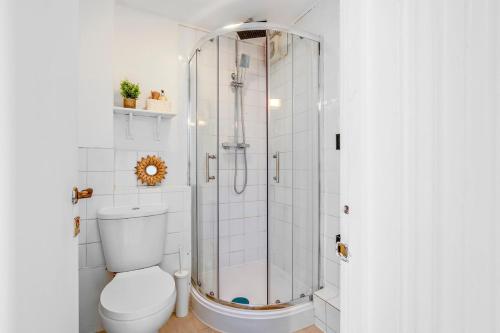 a bathroom with a shower and a toilet at Parking Outside Terrace Balcony Fulham ST in London