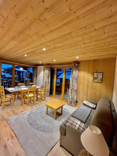 a living room with a couch and a table at Résidences Delavay La Cordée in Les Gets