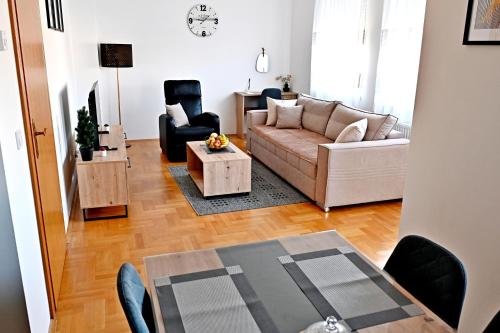 a living room with a couch and a table at Apartman Maela in Županja