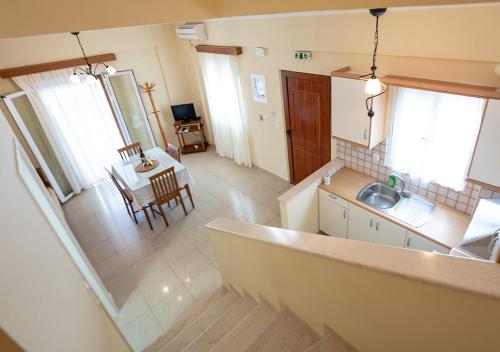 an aerial view of a kitchen and a dining room at Erietta Studios & Apartments by Kika Residences in Stoupa