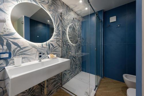 a bathroom with a sink and a mirror at Hotel Calliope in San Vito lo Capo
