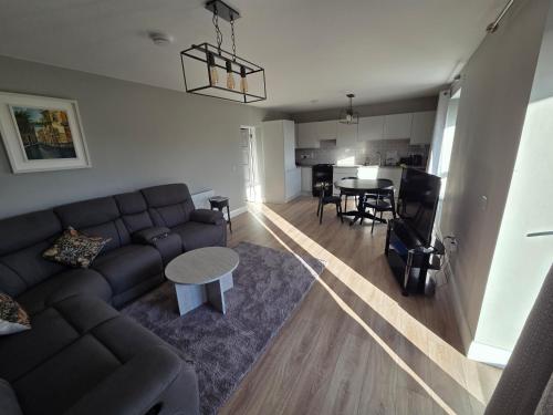 a living room with a couch and a table at Kilgar gardens in Kilcock