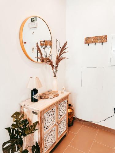a mirror on top of a dresser in a room at Cosy Apartment Queluz By Gt House in Queluz