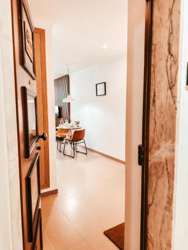 an open door to a dining room with a table at Cosy Apartment Queluz By Gt House in Queluz