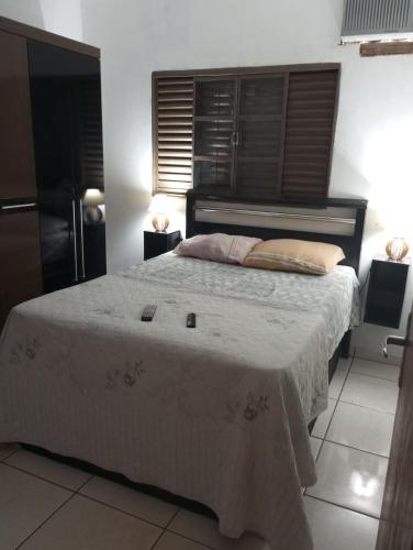a bedroom with a large bed with a white blanket at VERTT Engenharia in Campo Grande
