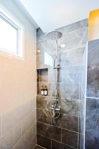 a shower with a shower head in a bathroom at Santara Pool Villa Udon in Udon Thani