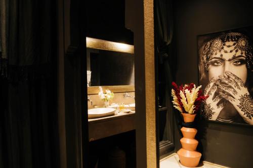 a bathroom with a large picture of a woman at Riad Nashira & Spa in Marrakesh