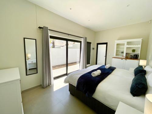 a bedroom with a large bed and a large window at Seaview Luxury loft apartment in Swakopmund