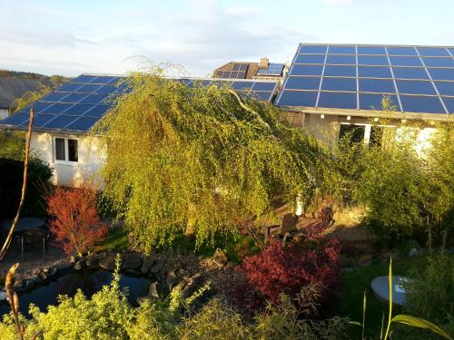a view of a house with solar panels on the roof at Ferienhaus Für Sieben Personen in Friedrichshausen