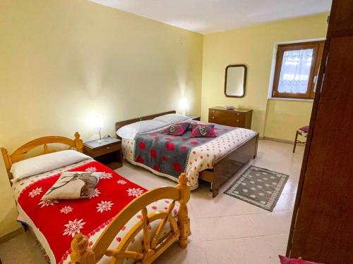 a bedroom with two beds and a mirror at Casa Vacanze - Villa Stefania in Pescocostanzo