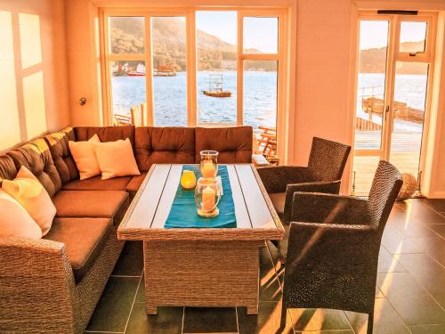 a living room with a couch and a table at Apartment Rorbuen by Interhome in Uggdal