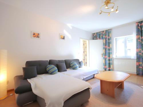 a living room with a couch and a table at Holiday Home Friedl by Interhome in Ritzing