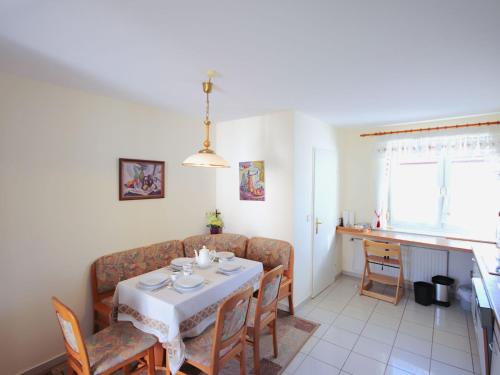 a dining room with a table and a couch at Holiday Home Friedl by Interhome in Ritzing