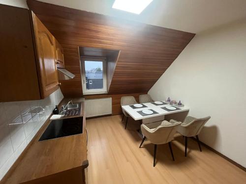 a kitchen with a table and chairs in a room at Apartment Airport Dortmund in Holzwickede