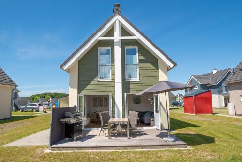 a house with a picnic table and an umbrella at Tweete Heimaat in Büsum