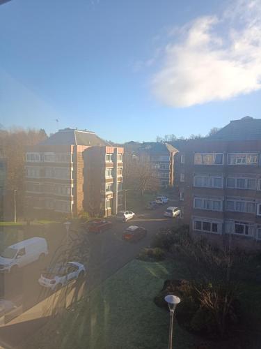 a view of a parking lot with buildings and cars at Open space studio in Shawlands in Glasgow